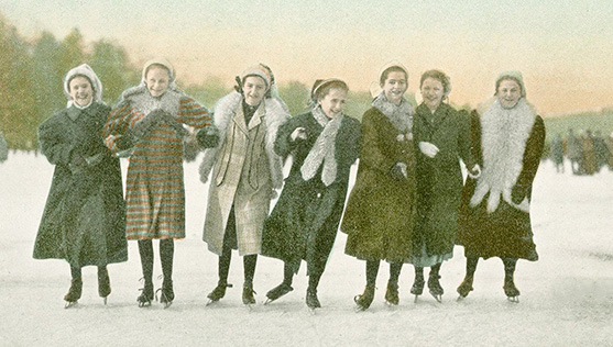 Group of young women skating with linked arms